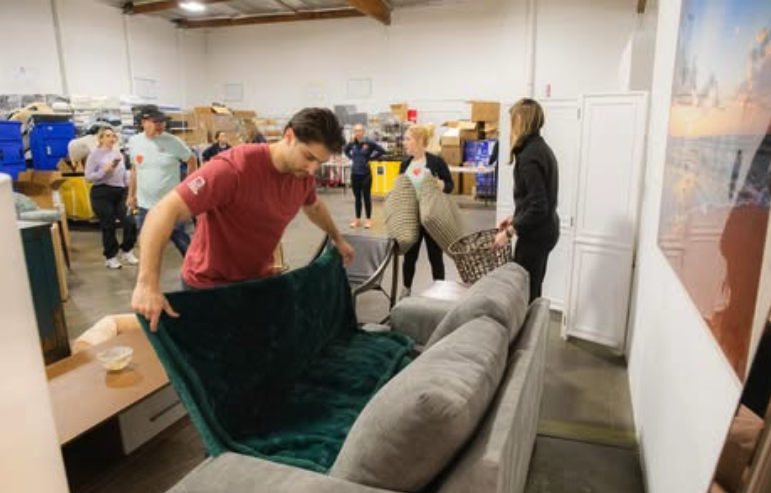 A volunteer stages furniture at the Home Bank LA warehouse — LA wildfires